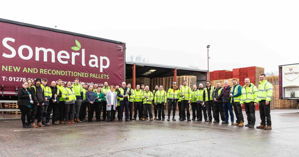 All the team at Somerlap stood in the courtyard in front of a lorry.